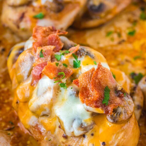 alice springs chicken with mushrooms bacon and cheese in a skillet.