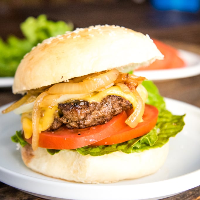 a homemade beef burger on a white plate