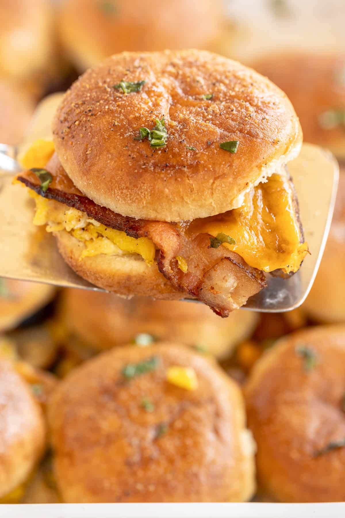 Breakfast sliders on a serving spatula.