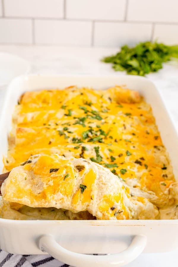 chicken enchiladas in a white baking dish