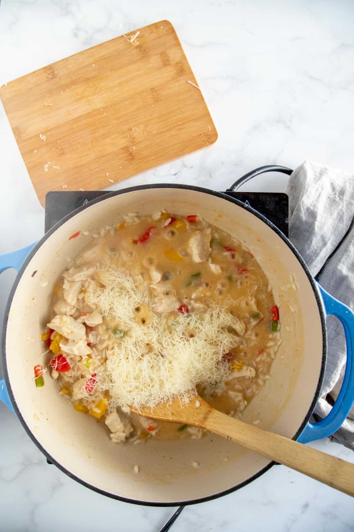 adding parmesan cheese to risotto