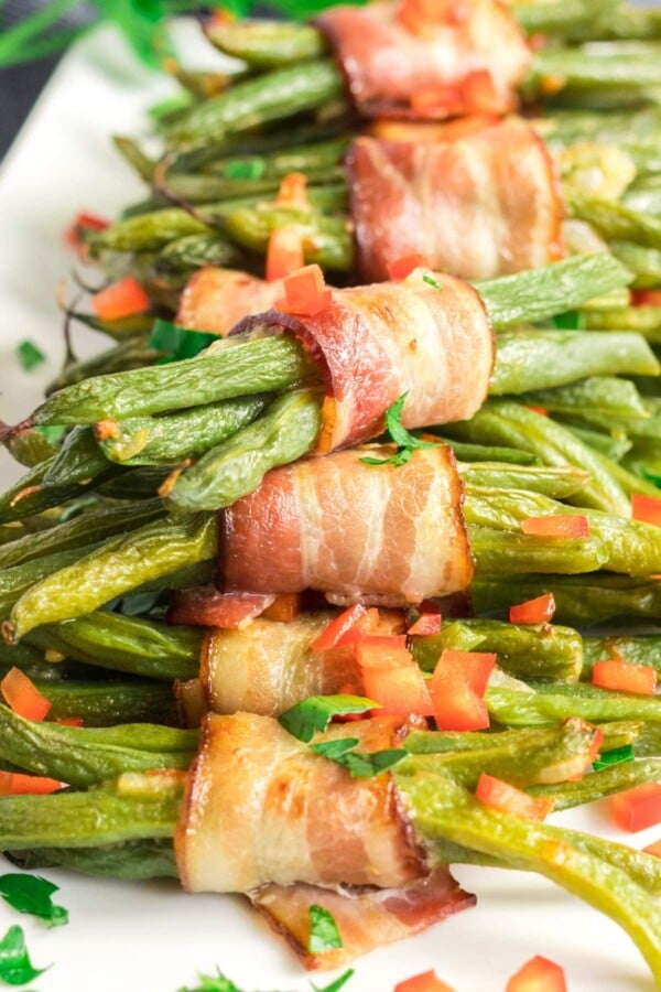 green bean bundles on a white platter