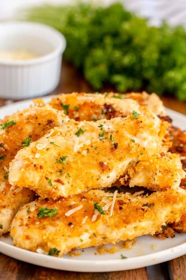 Breaded chicken tenders on a white plate