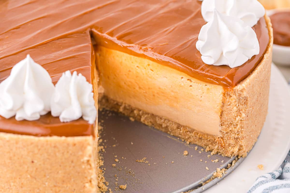 A Dulce de Leche Cheesecake cut open showing the inside filling.