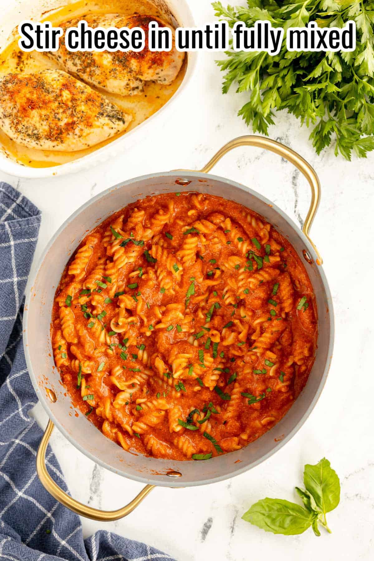 tomato pasta in a pot with parsley.