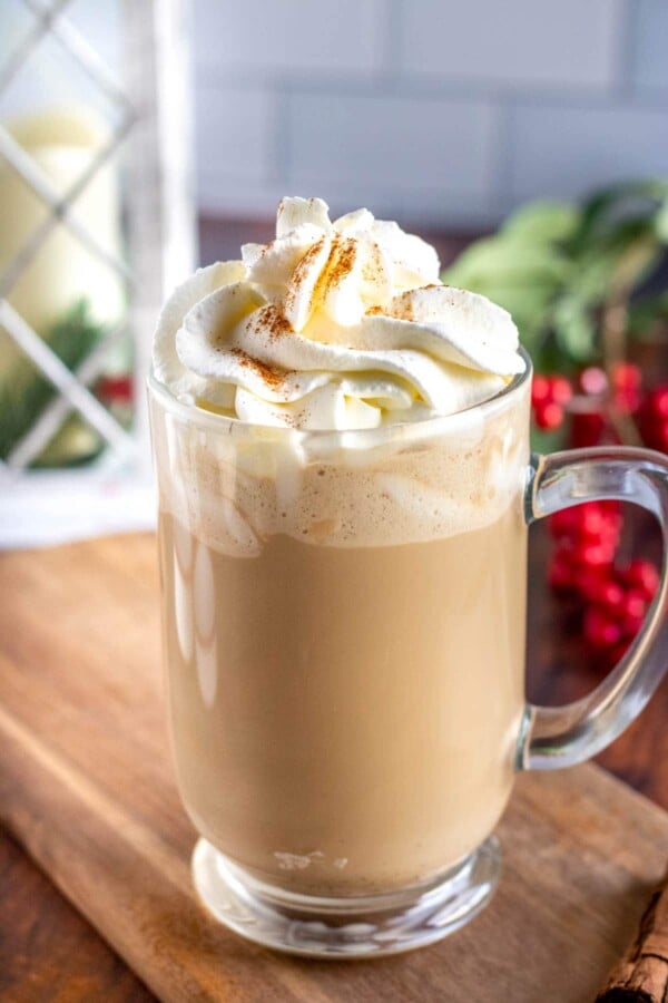 eggnog latte in a glass mug with whipped cream