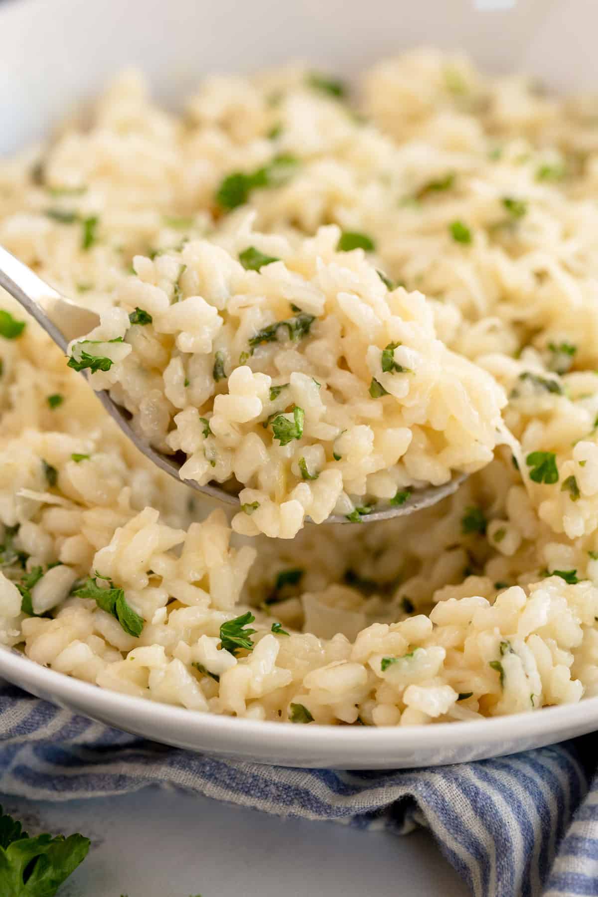 Creamy garlic parmesan risotto garnished with herbs.