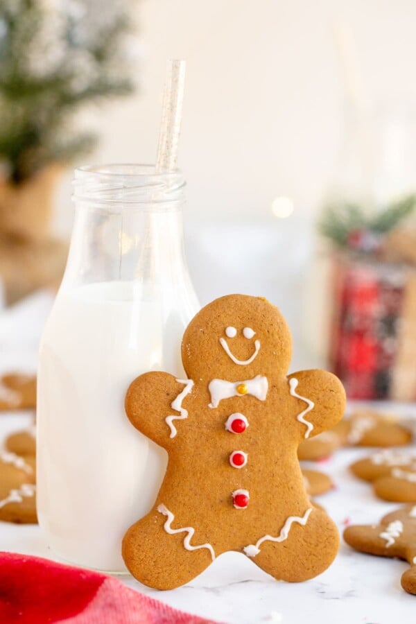 gingerbread man leaning on a glass of milk