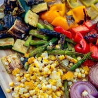 chopped grilled vegetables on a chopping board.