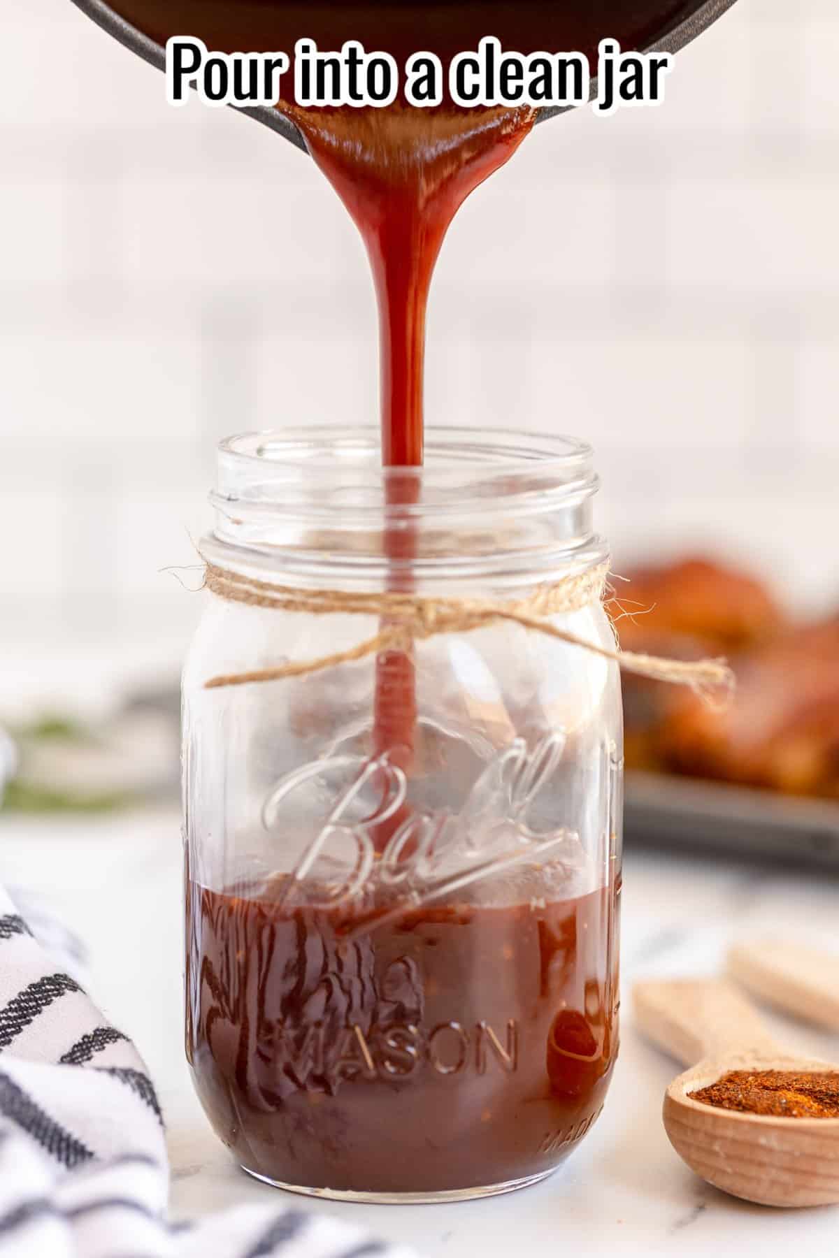 pouring bbq sauce into a mason jar.