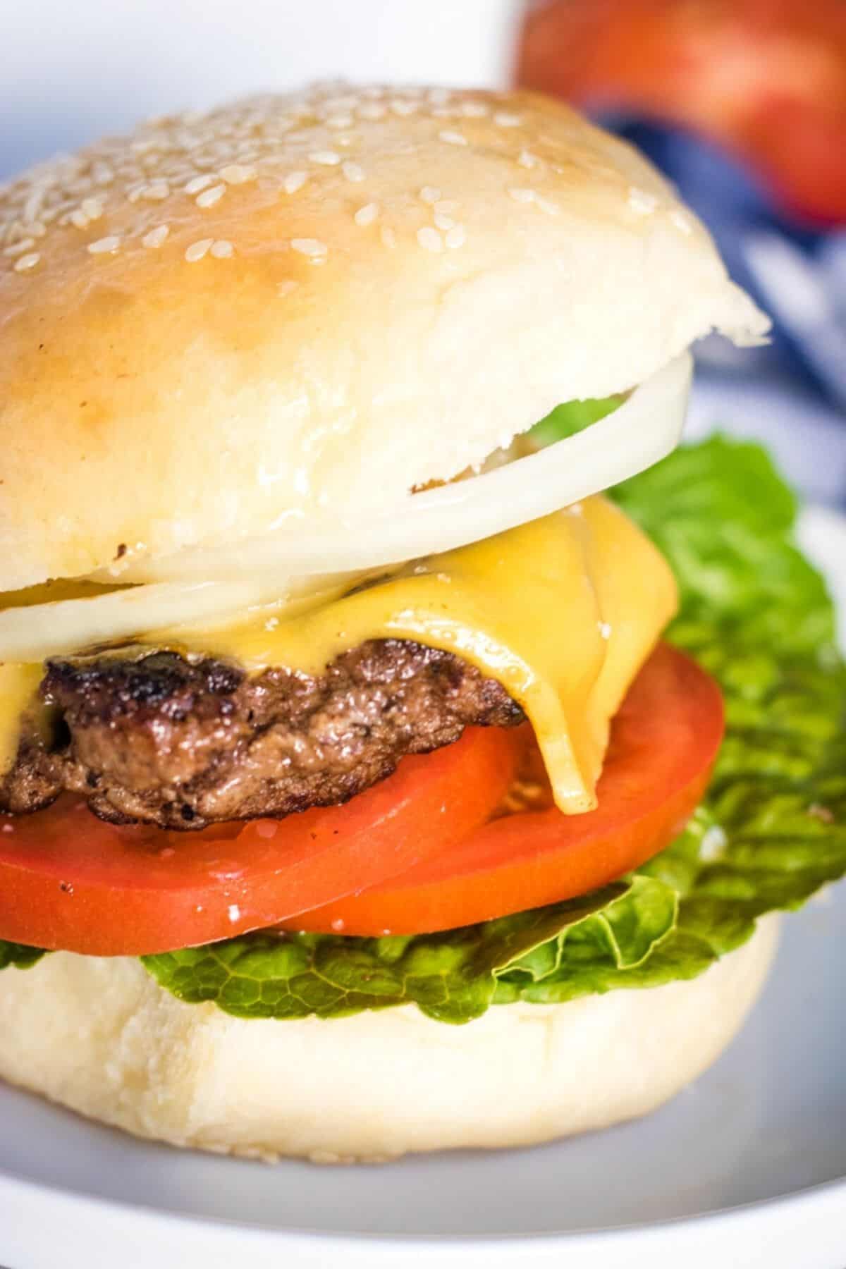 Burger with lettuce, tomato, cheese on a homemade hamburger bun