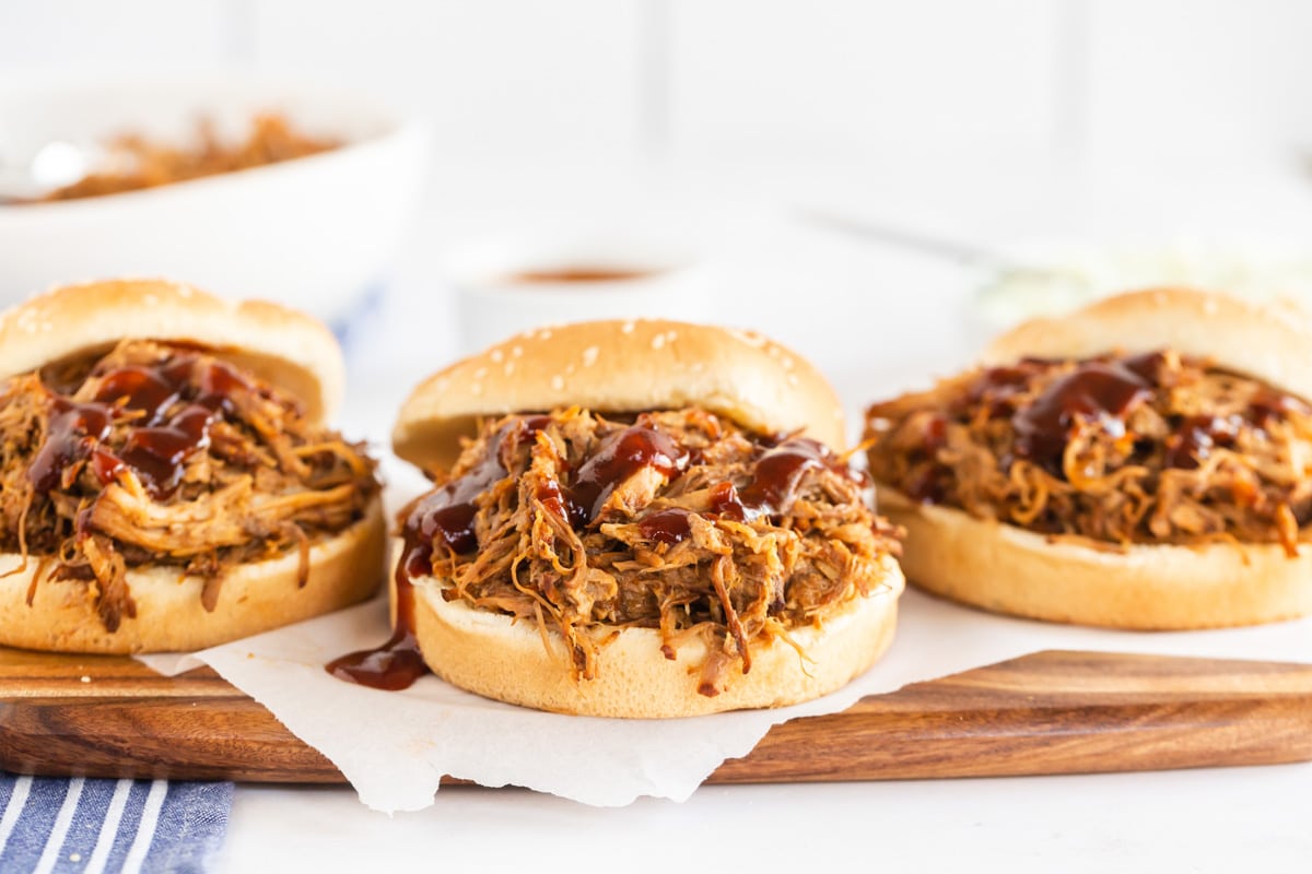 3 pulled pork sandwiches on sesame buns