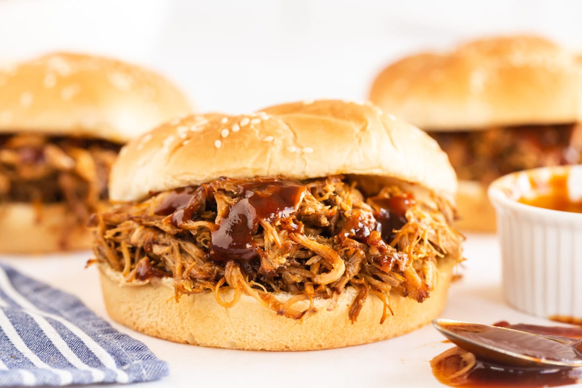 pulled pork in a sesame bun with sauce