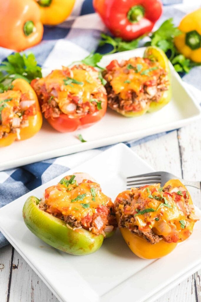 Stuffed peppers on a white plate with a fork