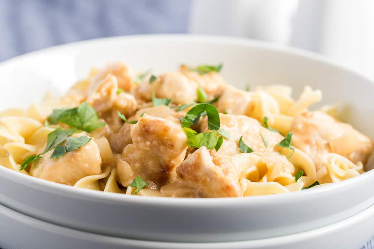 lemon chicken in a bowl with parsley sprinkled over the top