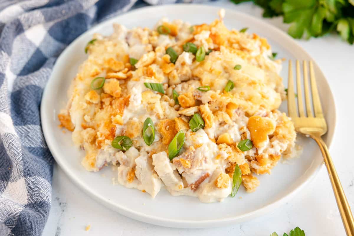 chicken casserole on a plate with a gold fork.