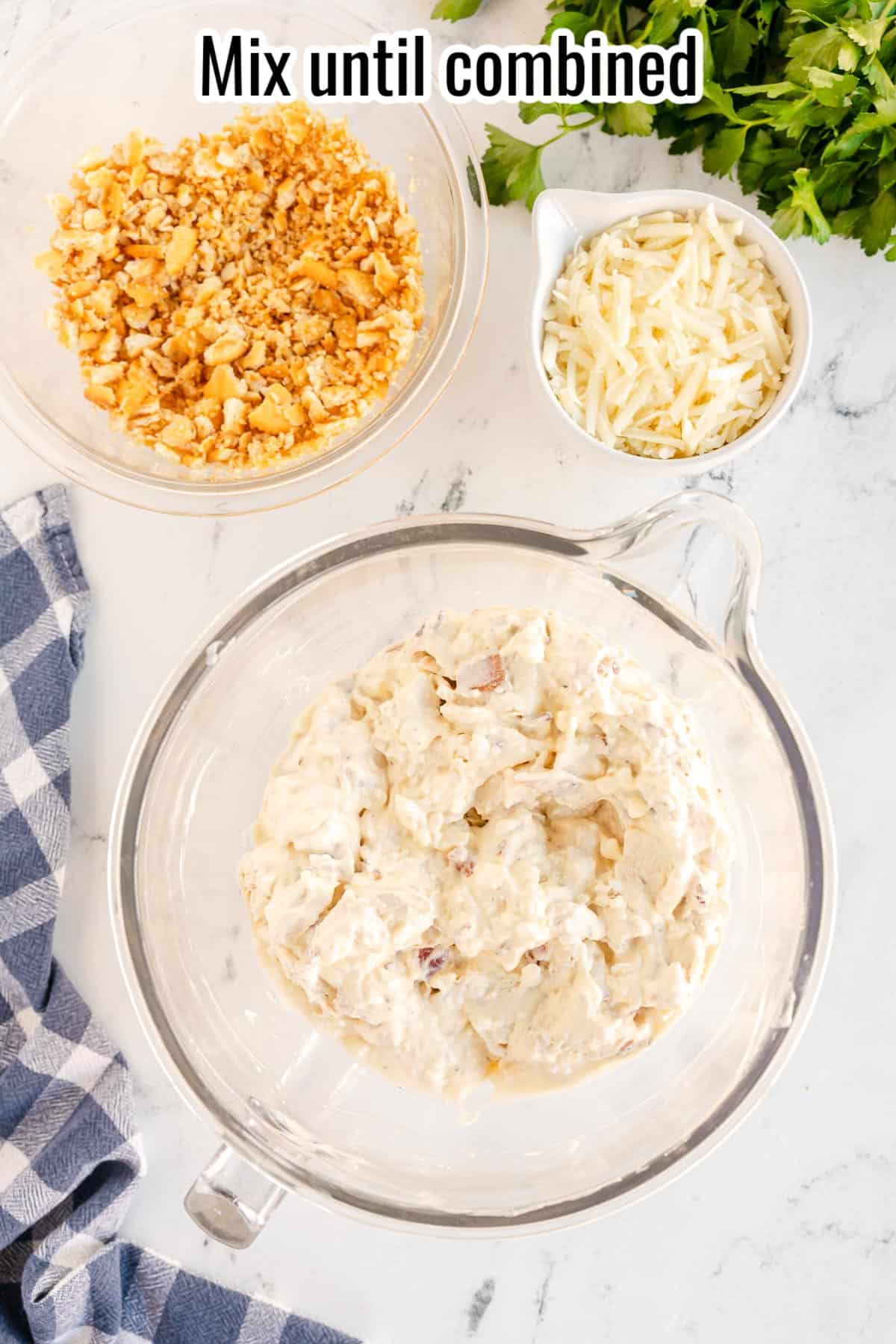 chicken and bacon mixed in a bowl with sauce for million dollar chicken casserole.