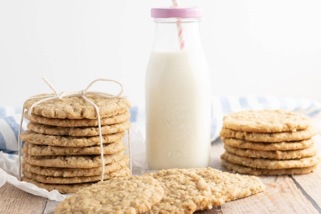 oatmeal cookies stacked and tied with twine, with a bottle of milk and pink lid