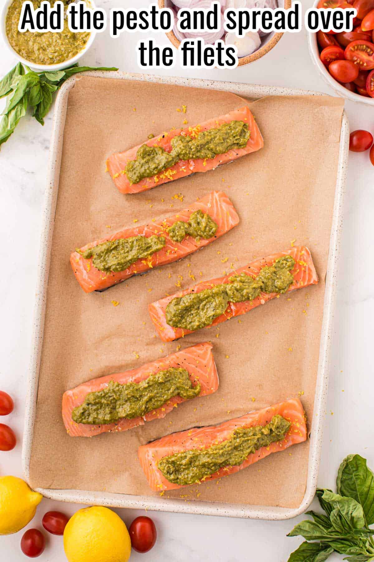 raw salmon with pesto on a sheet pan.