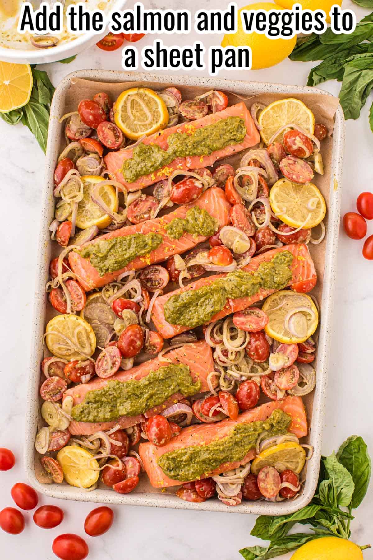 unbaked pesto salmon on a sheet pan.