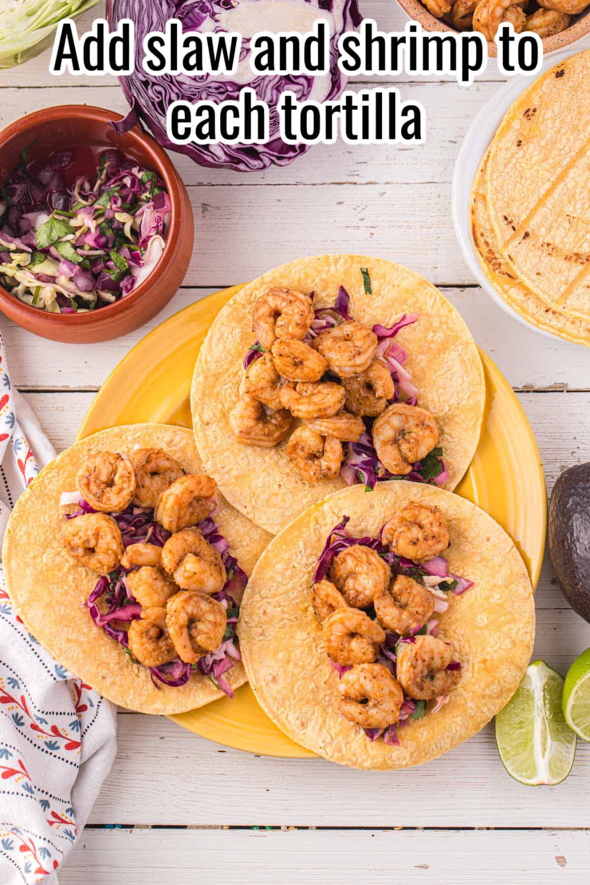 a yellow plate with 3 baja shrimp tacos.