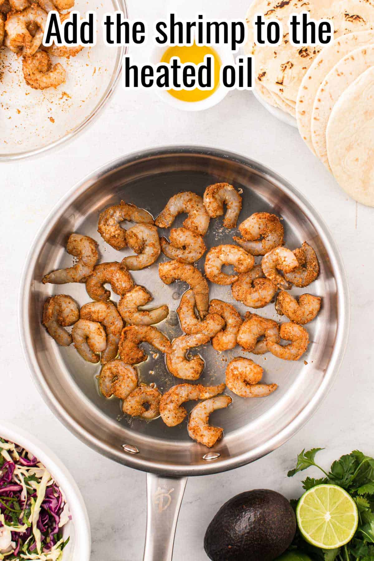 a skillet with uncooked baja shrimp.