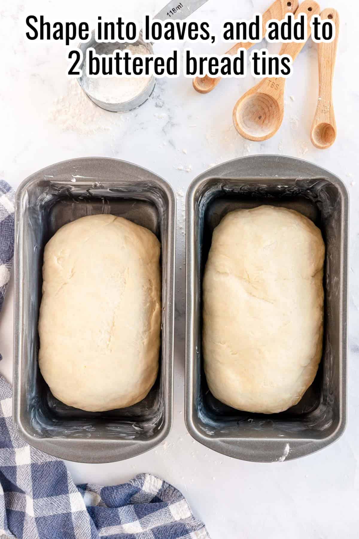 Two unbaked bread loaves in buttered bread tins. Text instructs to shape the dough into loaves and place them in the tins.