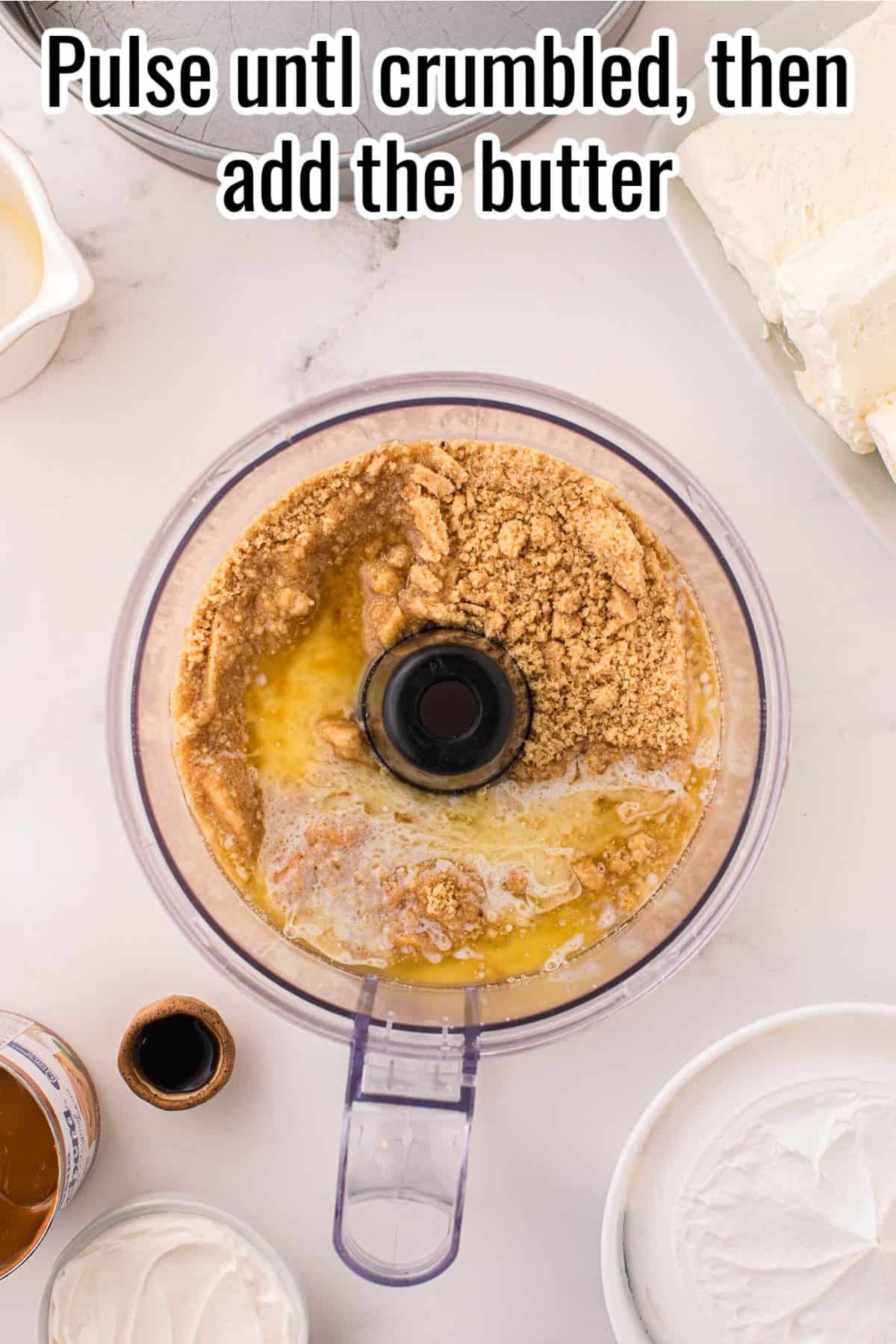 A food processor with crumbs and butter.