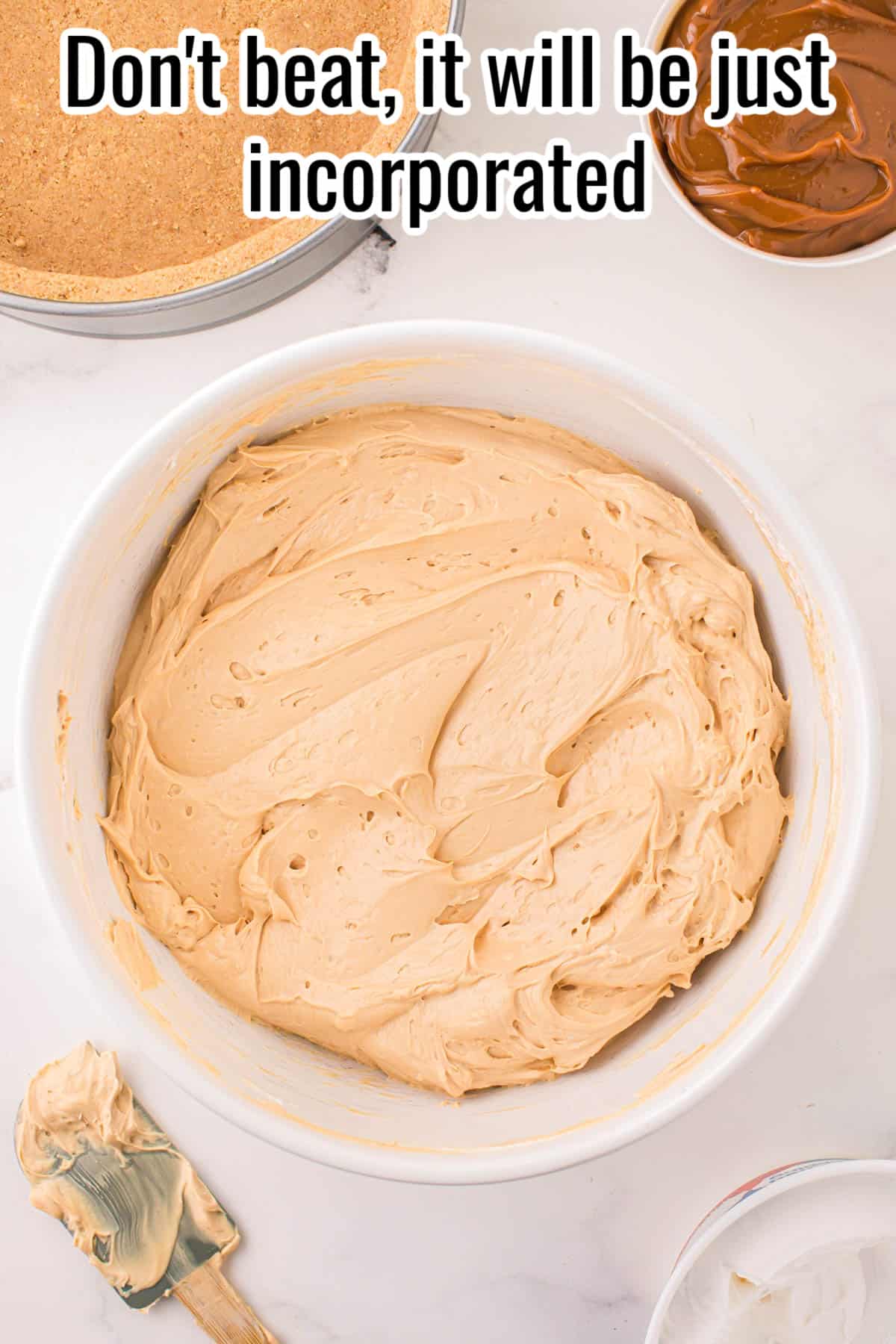 Cheesecake batter in a white bowl.