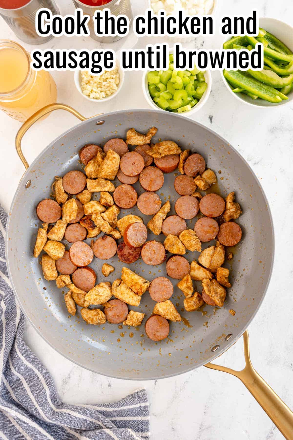 a skillet with browned chicken and sausage.