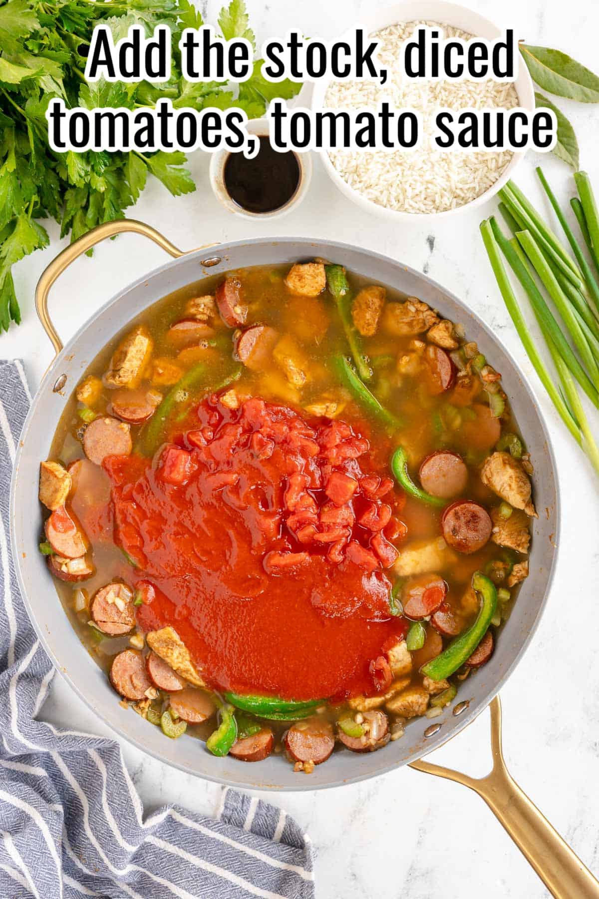 a skillet with tomatoes and stock added to sauteed veggies.