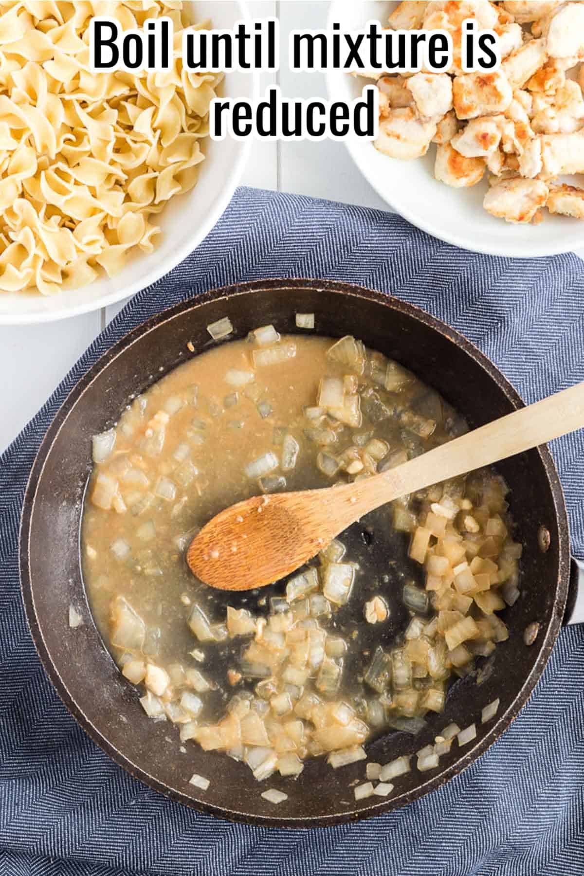 a black skillet with a wooden spoon and reduced liquid in it.