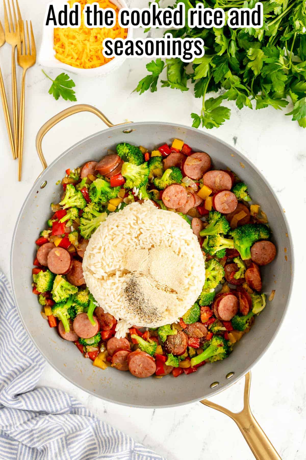 smoked sausage and veggies in a skillet with rice and seasonings.