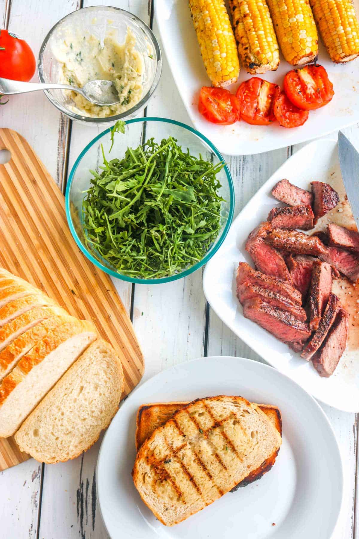 cooked ingredients ready to assemble a steak sandwich.